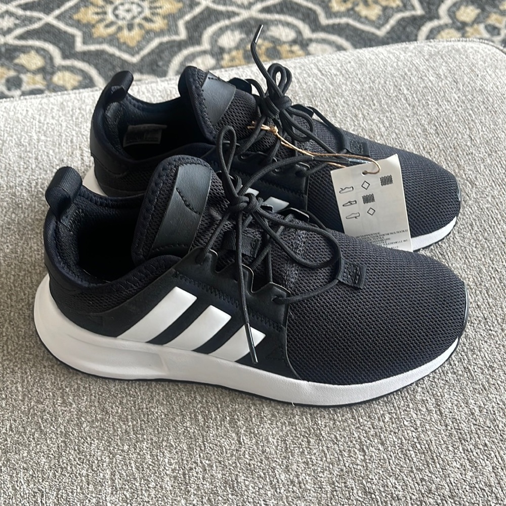 Black and white adidas kids size 4.